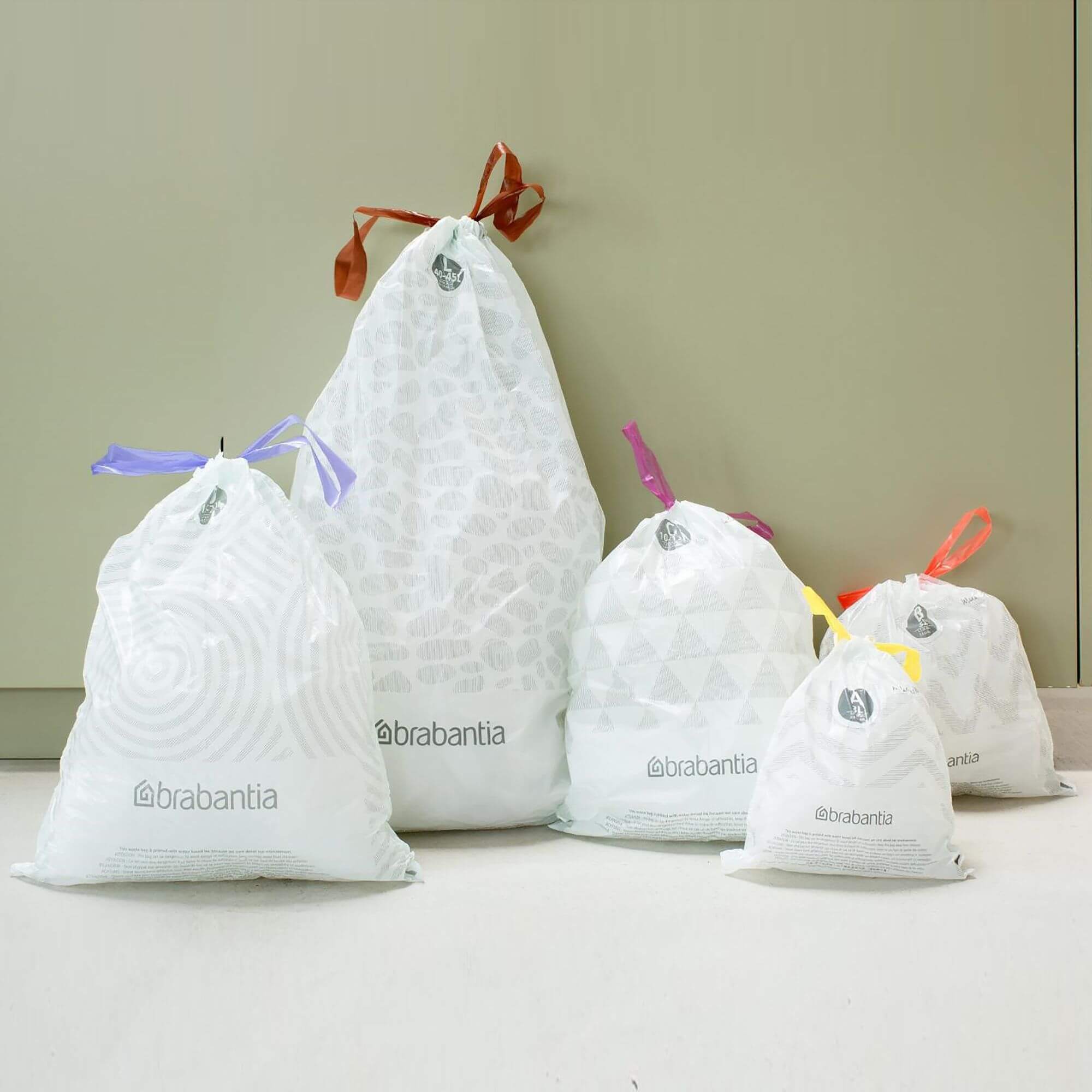 Five Brabantia rubbish bin liners standing up in a kitchen