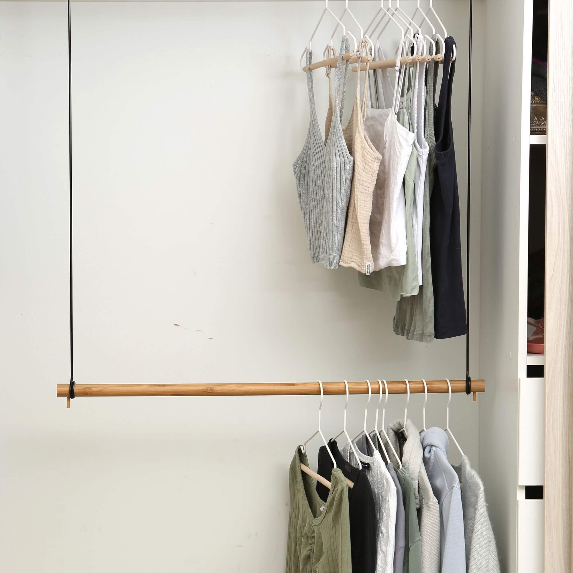 Clothes hanging on a wooden wardrobe clothes rail