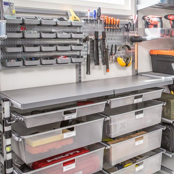 Eight Platinum Elfa Gliding Mesh Drawers installed in a garage