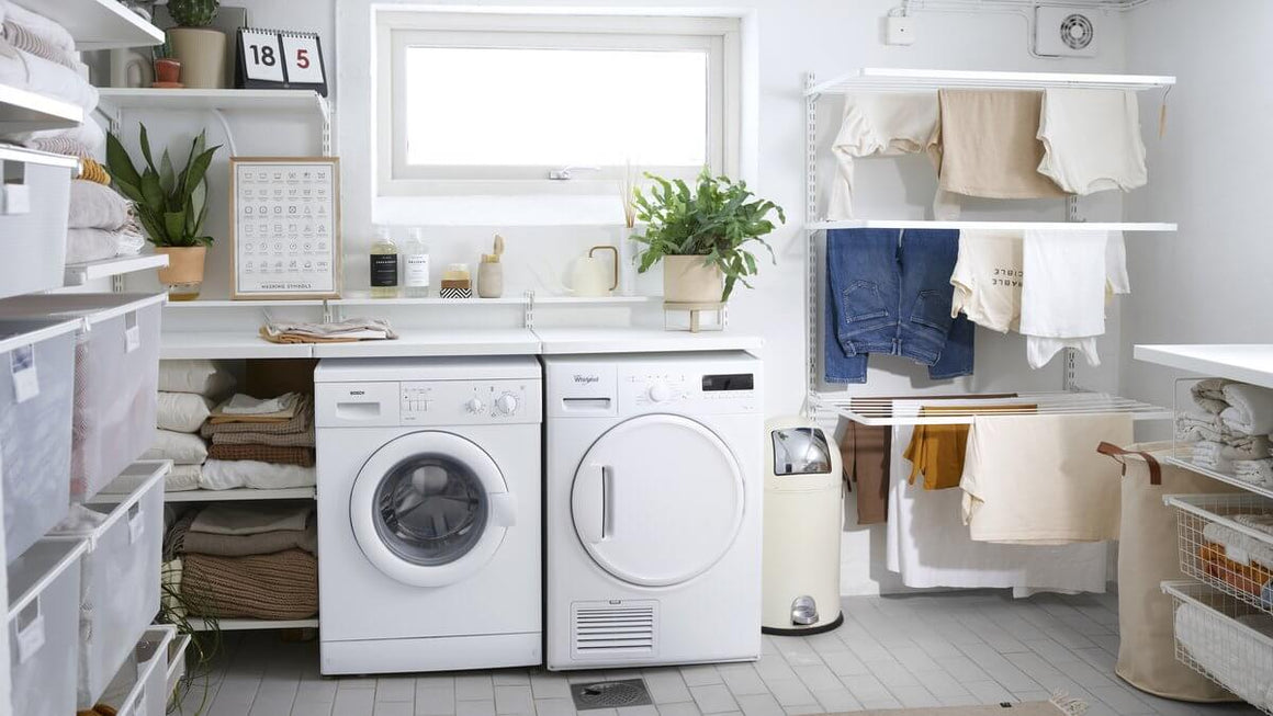 A laundry room fitted out with White Elfa shelving, drawers and clothes drying racks