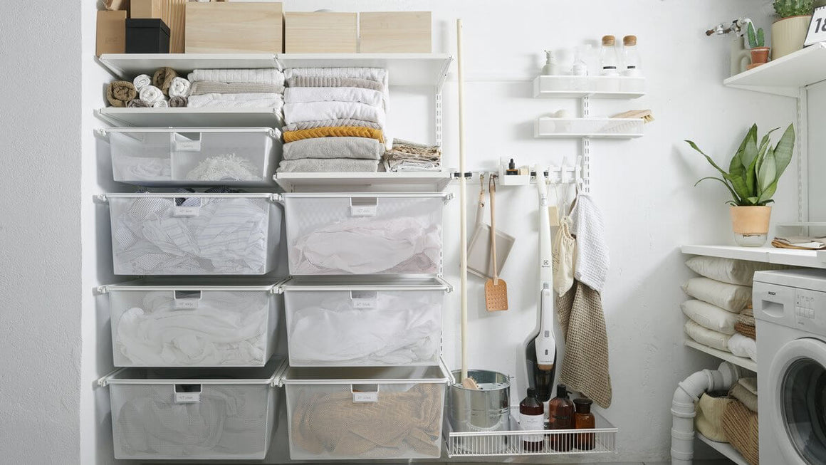 White Elfa Gliding Mesh Drawers installed in a laundry as wall-mounted clothes hampers