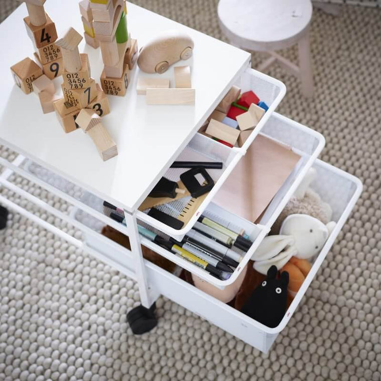 Toys, books and stationery stored in a White Elfa Freestanding Drawer Kit