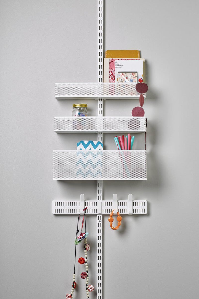 A White Elfa Utility Wall & Door system with Mesh Utility Baskets and a Centre Storing Board, used for stationery storage