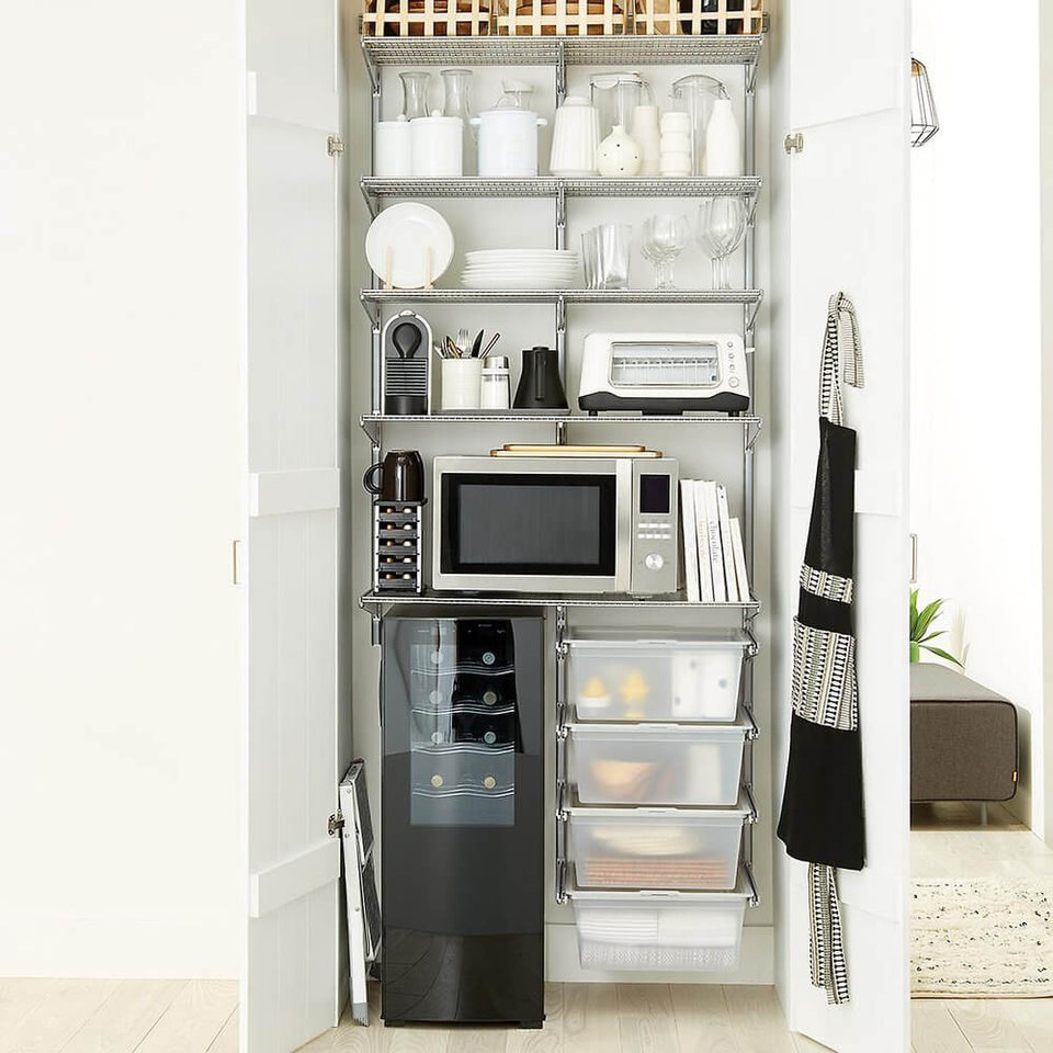 Platinum Elfa shelving installed in a built-in pantry The metal shelves are used for organising glassware, plates and utensils.