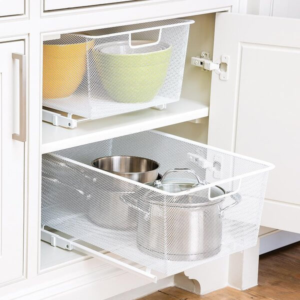 Two White Elfa Easy Gliders installed in a kitchen cupboard, with pots, pans and bowls organised inside